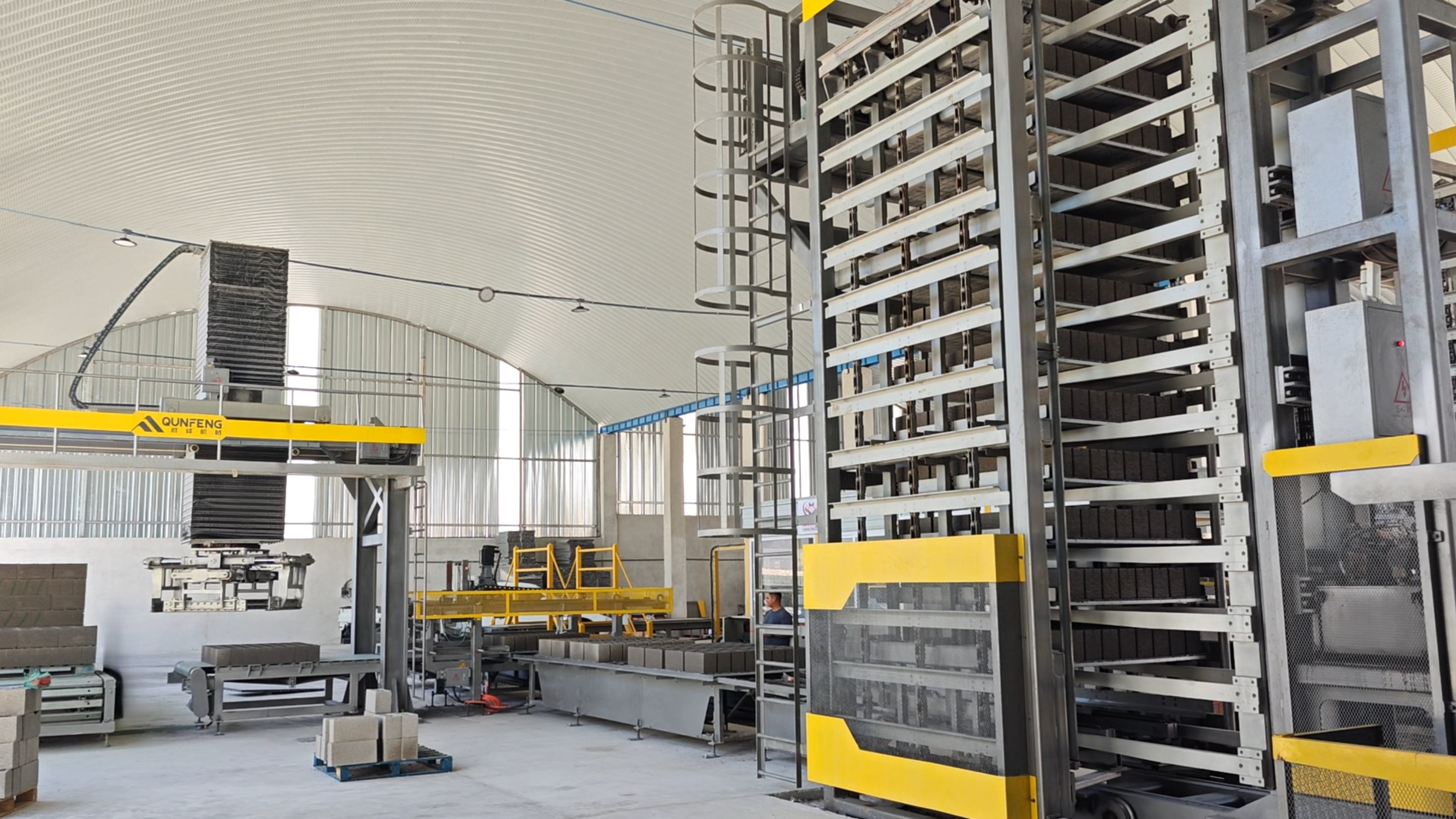 Qunfeng's customized block making solution successfully overcoming volcanic ash processing challenges Detailed view of the automated concrete block production line equipment in Guatemala